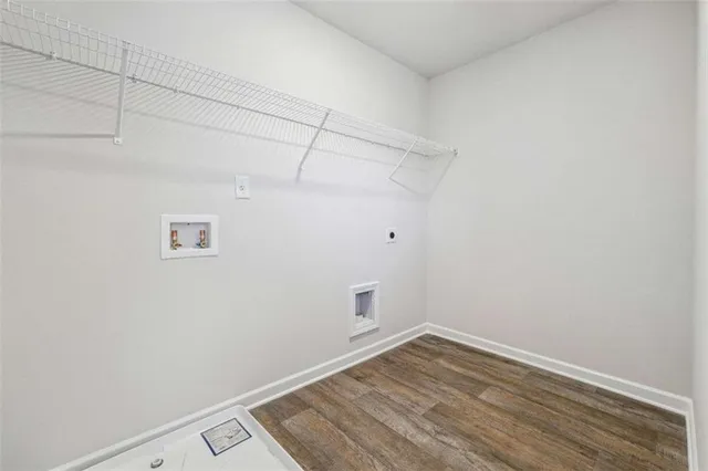 a view of a room with wooden floor