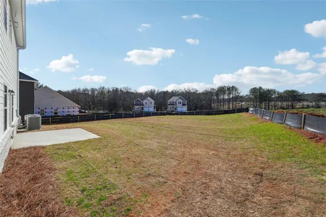 a view of a swimming pool and a yard
