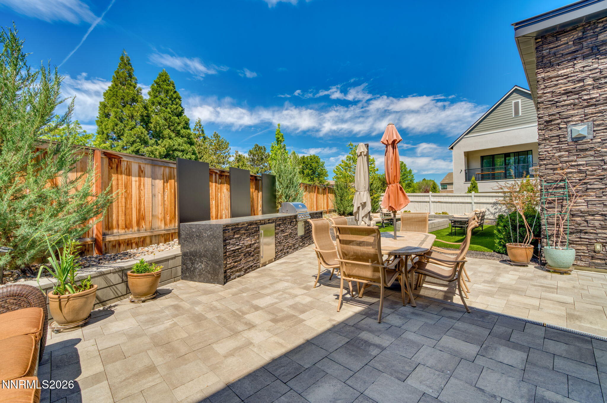 6141 Triple Crown Drive Reno, NV 89511 - Photo 27 of 71 a view of a patio with dining table and chairs with a fire pit