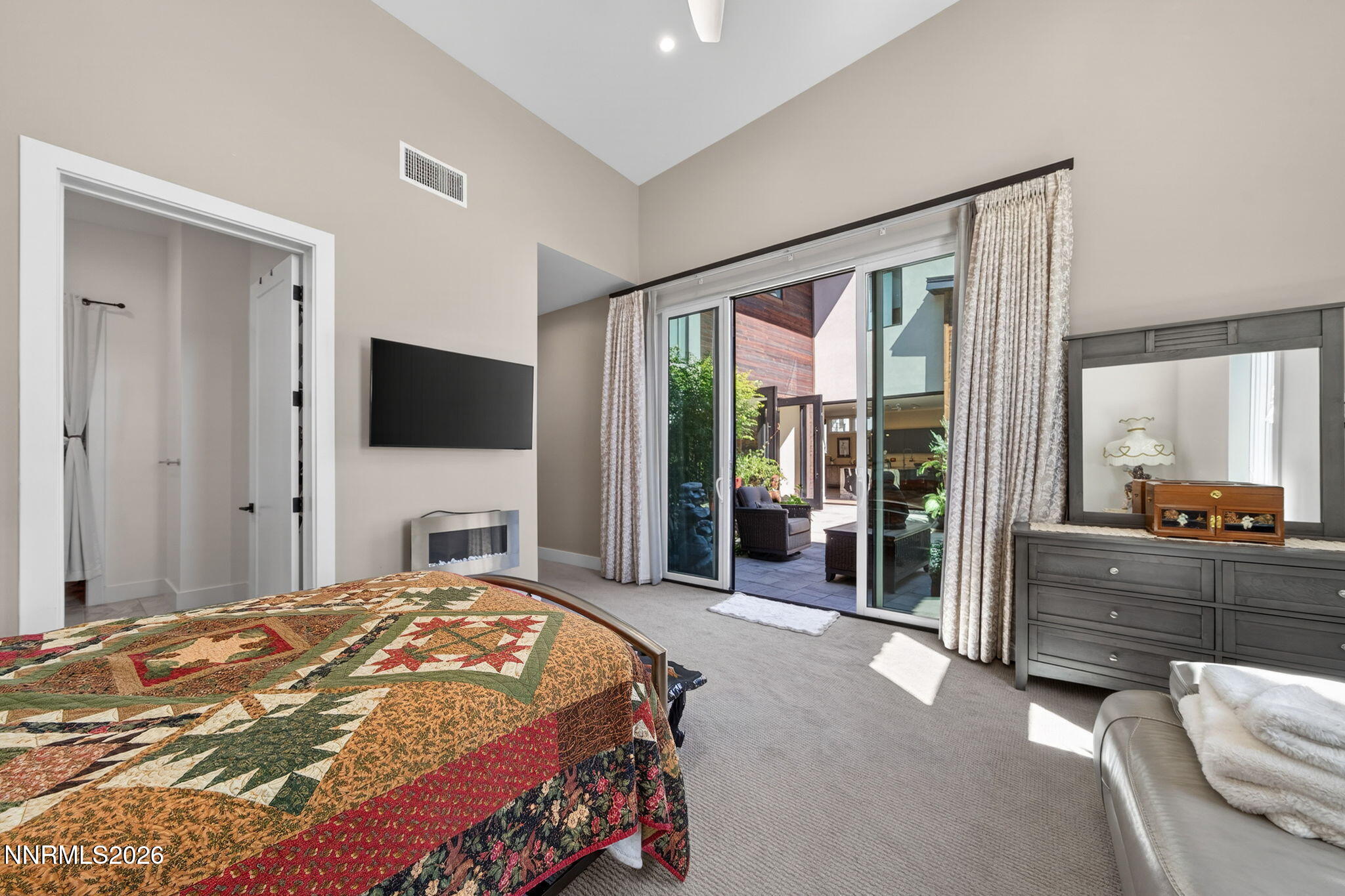 6141 Triple Crown Drive Reno, NV 89511 - Photo 53 of 71 a bedroom with a large bed and a flat tv screen