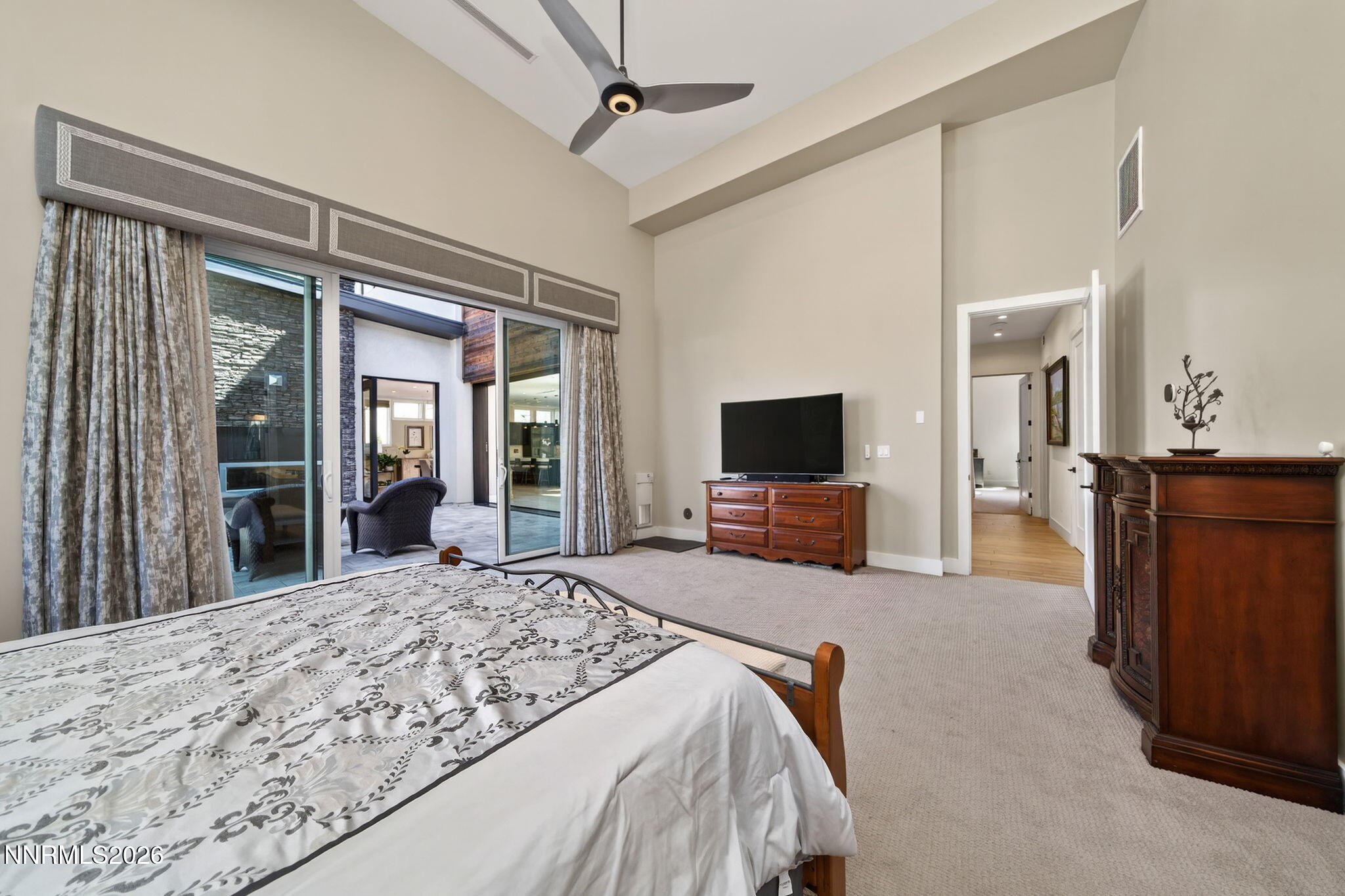 6141 Triple Crown Drive Reno, NV 89511 - Photo 59 of 71 a bedroom with a bed and a flat screen tv