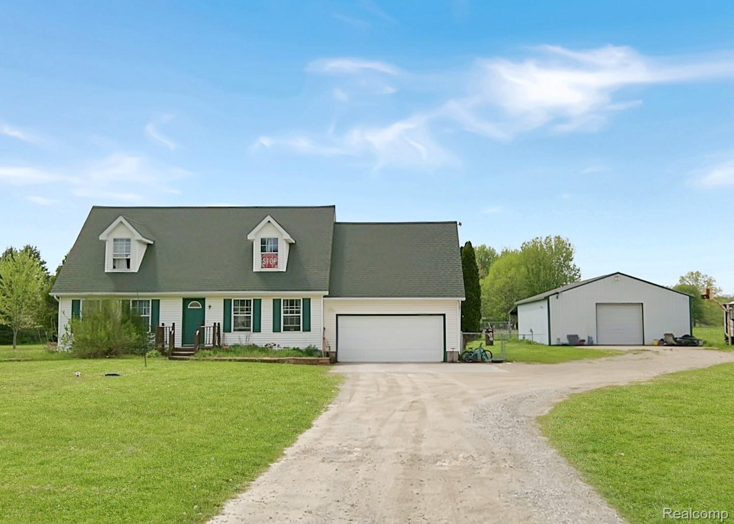 6533 Kilburn Road Jeddo, MI 48032 - Photo 1 of 19 Cape cod-style house with a front yard, dirt driveway, and a garage