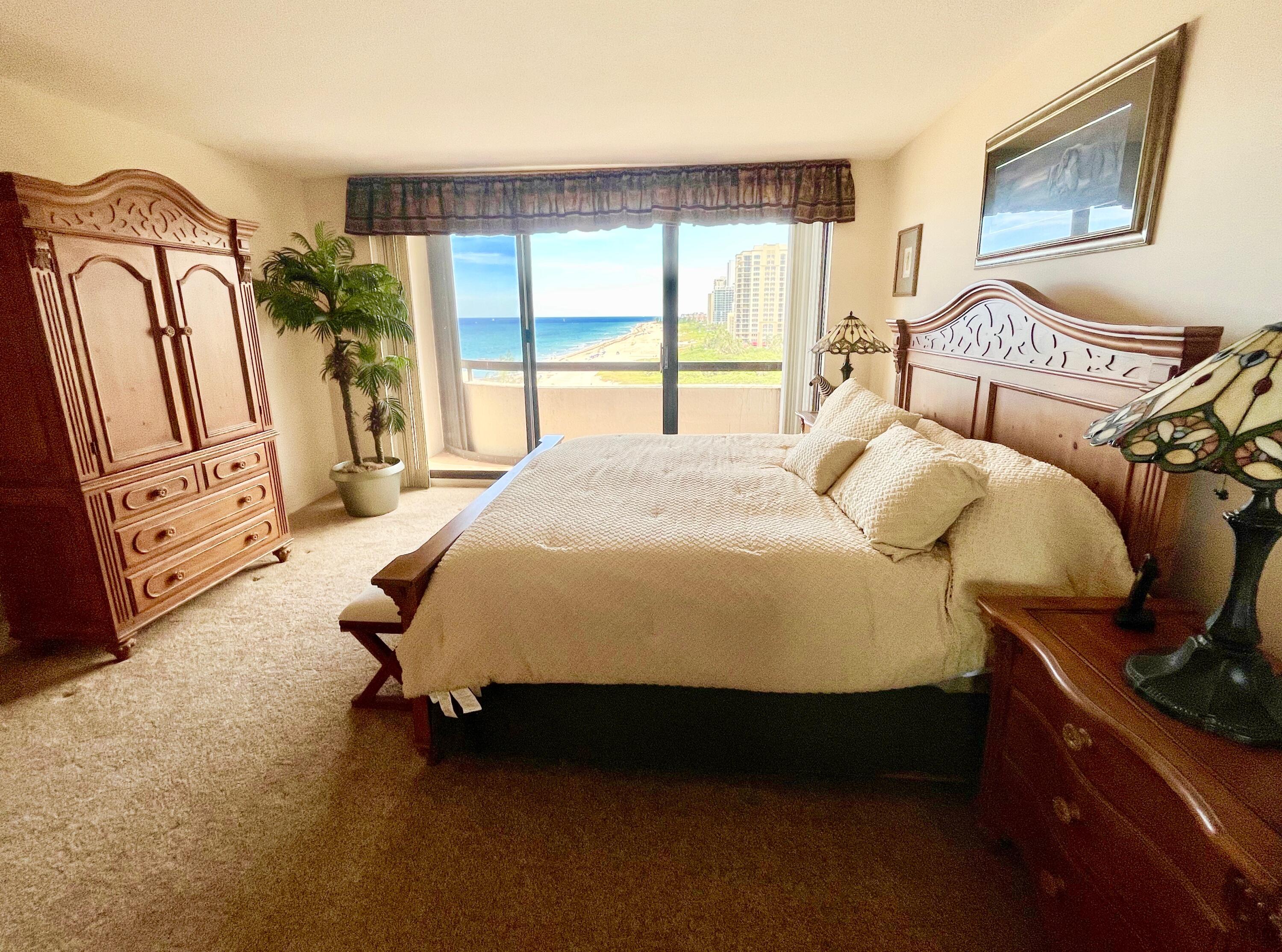 4000 North Ocean Drive, Unit 902 Singer Island, FL 33404 - Photo 19 of 53 a bed sitting in a bedroom next to a window