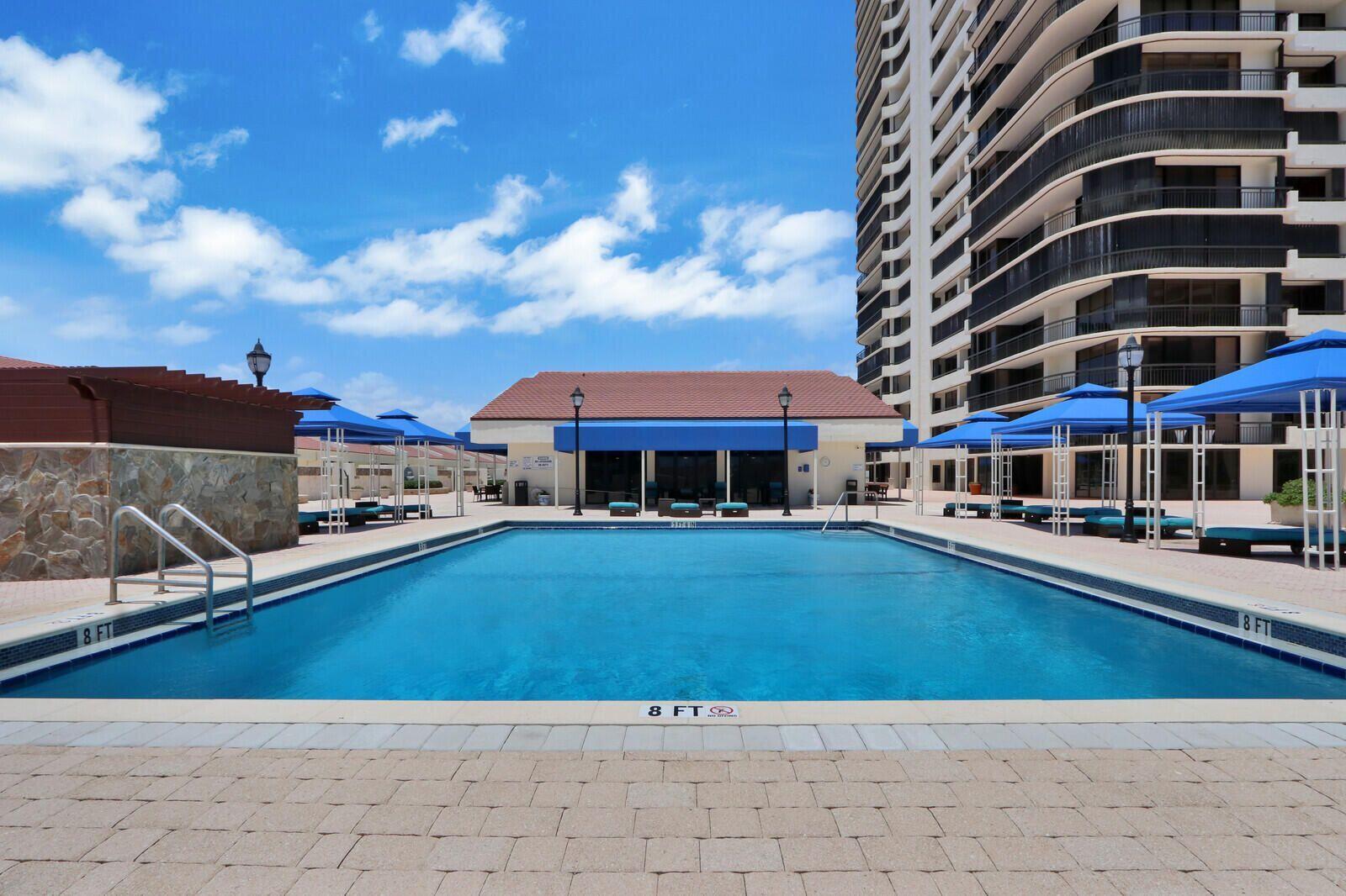 4000 North Ocean Drive, Unit 902 Singer Island, FL 33404 - Photo 39 of 53 a front view of a building with cars parked