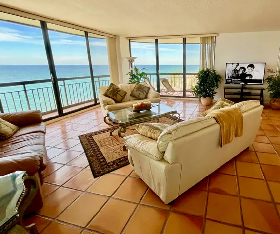 a living room with furniture and large windows