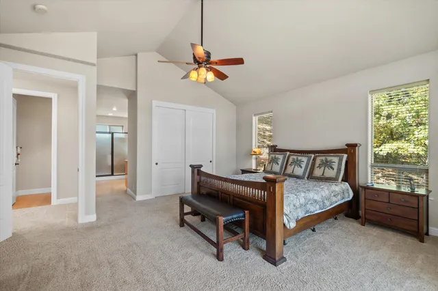 a bathroom with a granite countertop double vanity sink a bathtub a mirror and vanity