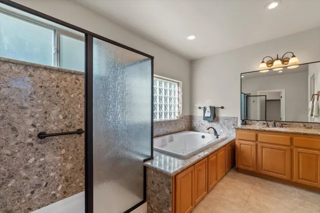 a bathroom with a granite countertop sink a toilet and a mirror