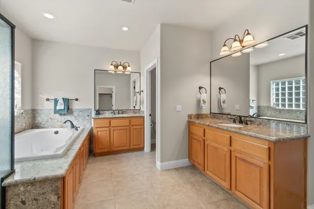 a view of walk in closet with clothes