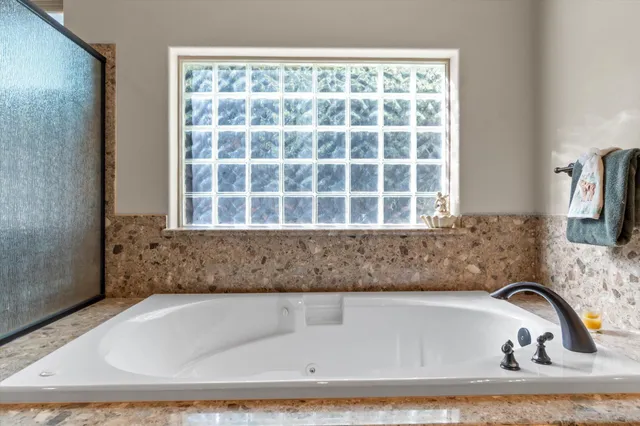 a bathroom with a granite countertop sink