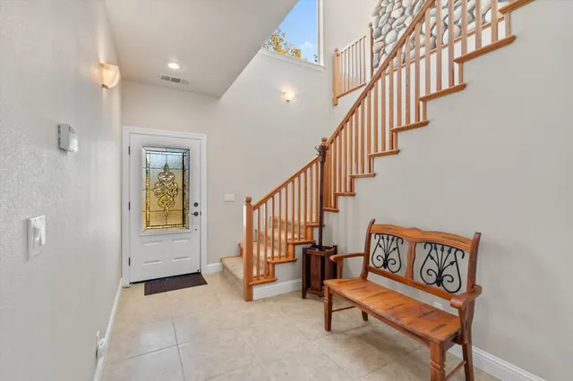 a bathroom with a granite countertop toilet sink and mirror