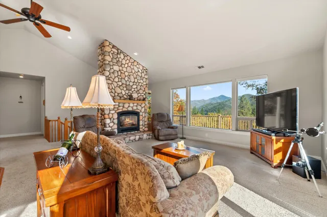 a kitchen with stainless steel appliances granite countertop a sink a stove and a refrigerator