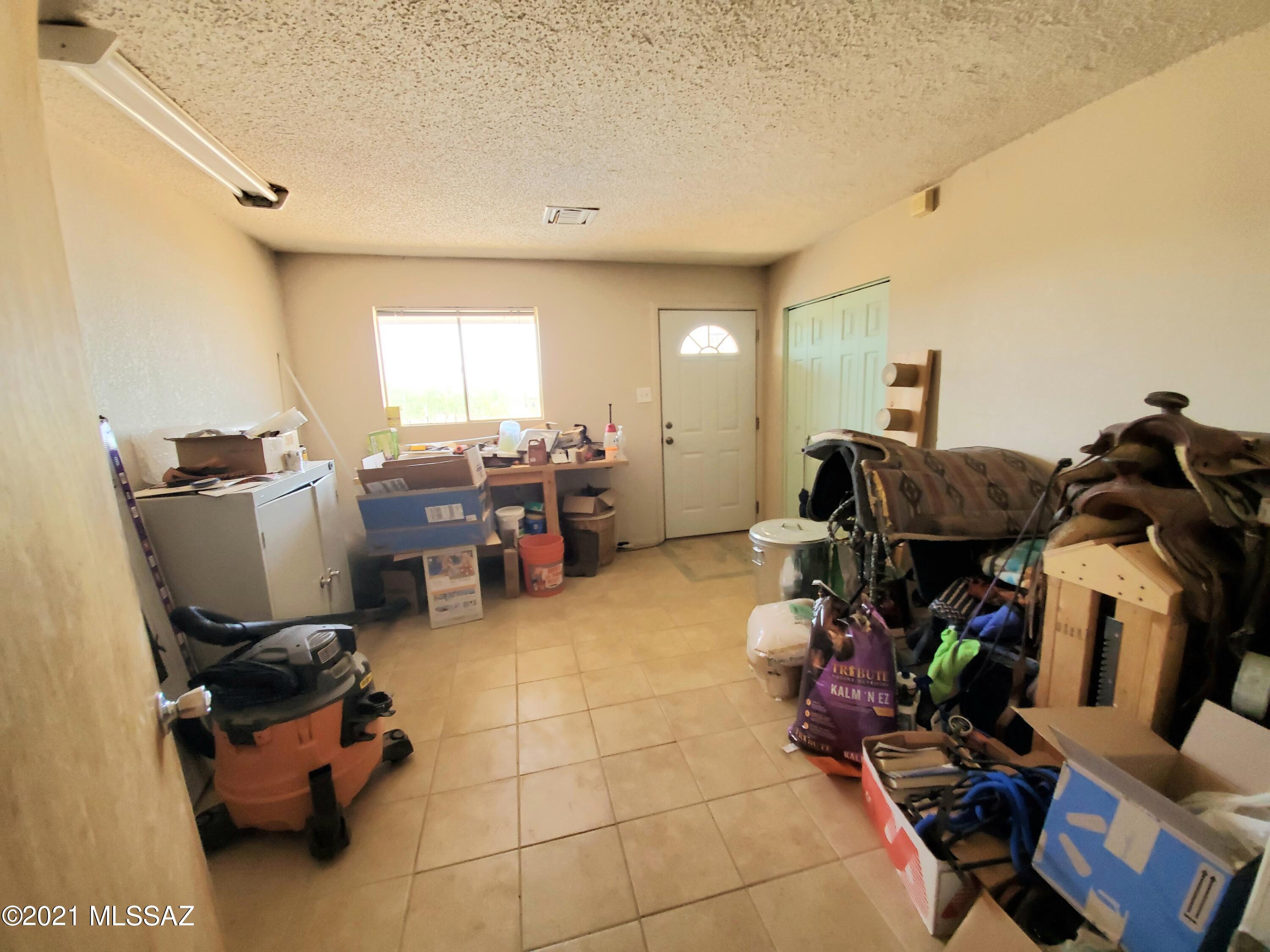 3440 East Howling Wolf Road Willcox, AZ 85643 - Photo 22 of 45 a room with gym equipment and a large window