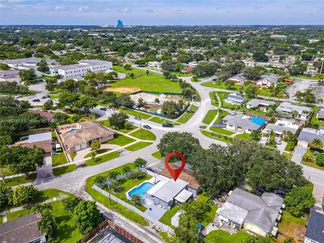 an aerial view of residential houses with outdoor space and street view