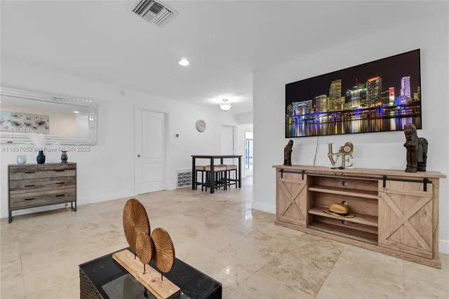 a kitchen with a refrigerator a stove a sink dishwasher with a dining table and chairs