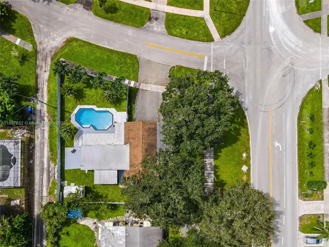 an aerial view of a house with garden space and outdoor seating