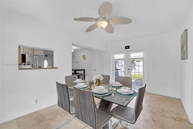 a bedroom with two beds and painting on the wall