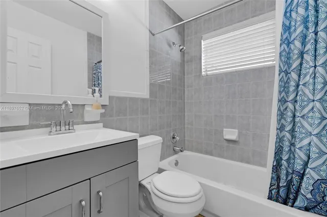 a bedroom with a bed lamp and a window