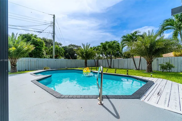 a view of swimming pool with a yard