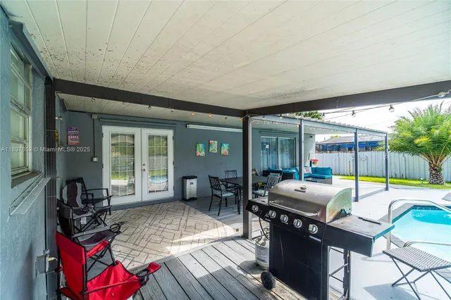 swimming pool view with a seating space and a garden view