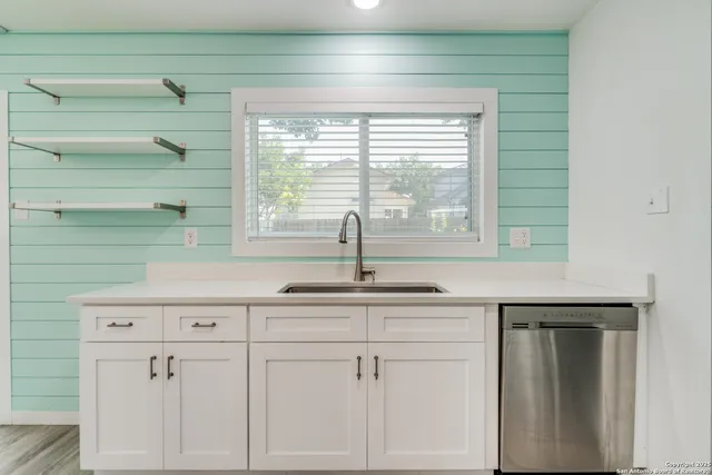 a kitchen with a sink and cabinets