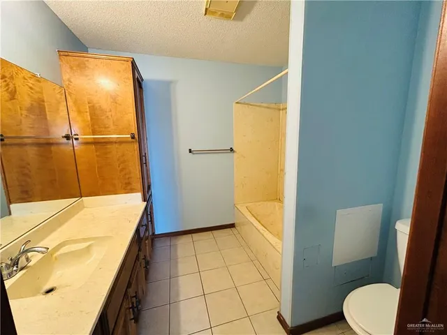 a view of a utility room with closet and mirror