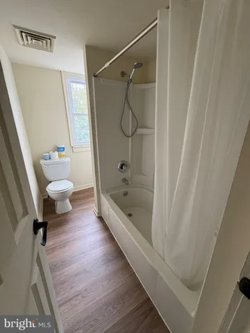 a bathroom with a bathtub a toilet and a shower