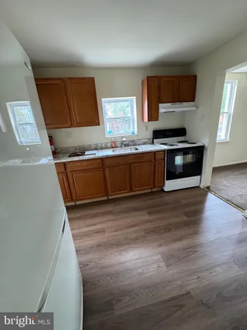 a kitchen with stainless steel appliances kitchen island granite countertop a stove a sink and a microwave