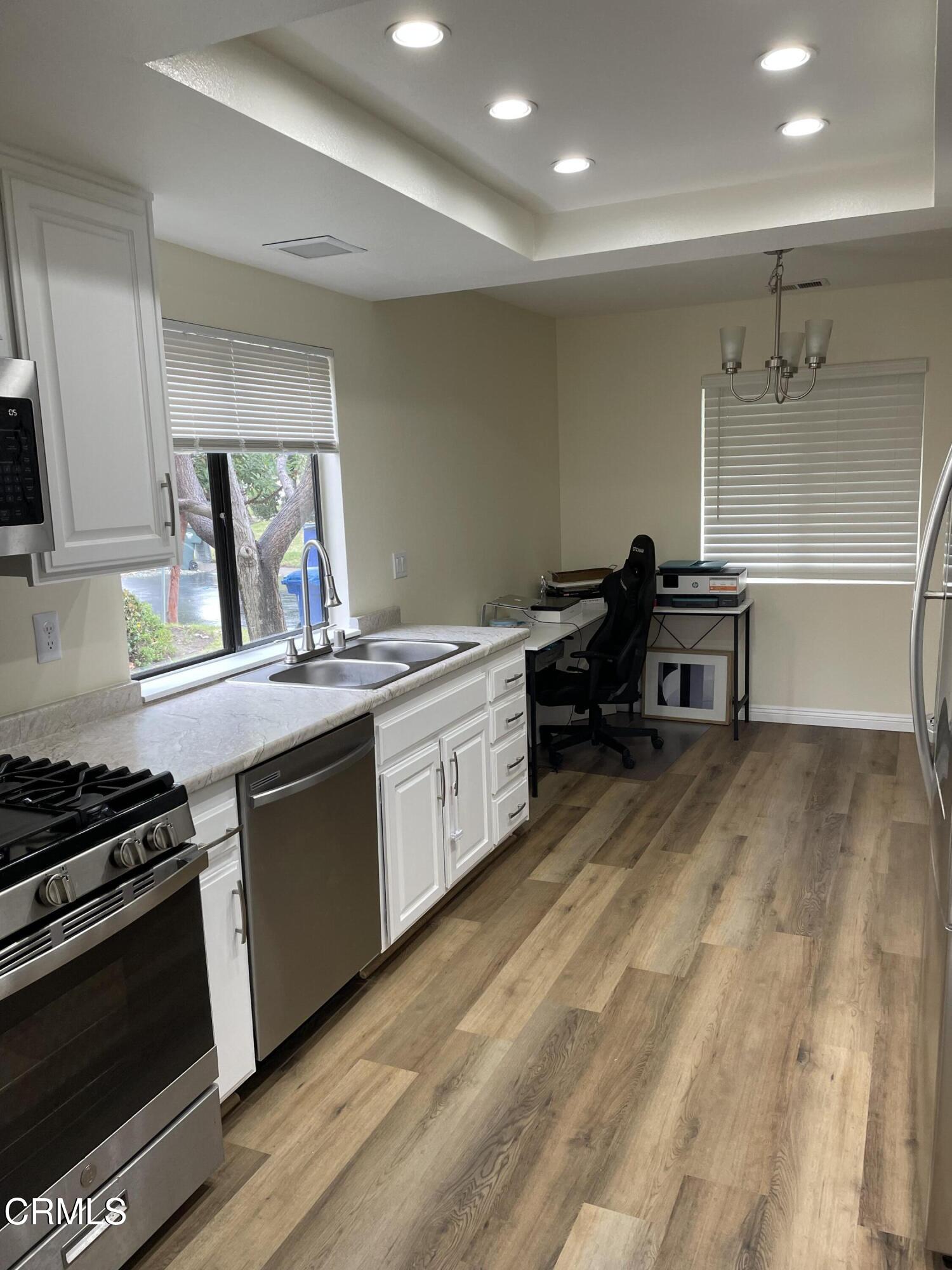 2585 Pheasant Hill Road Camarillo, CA 93010 - Photo 5 of 23 a kitchen that has a sink and a stove in it