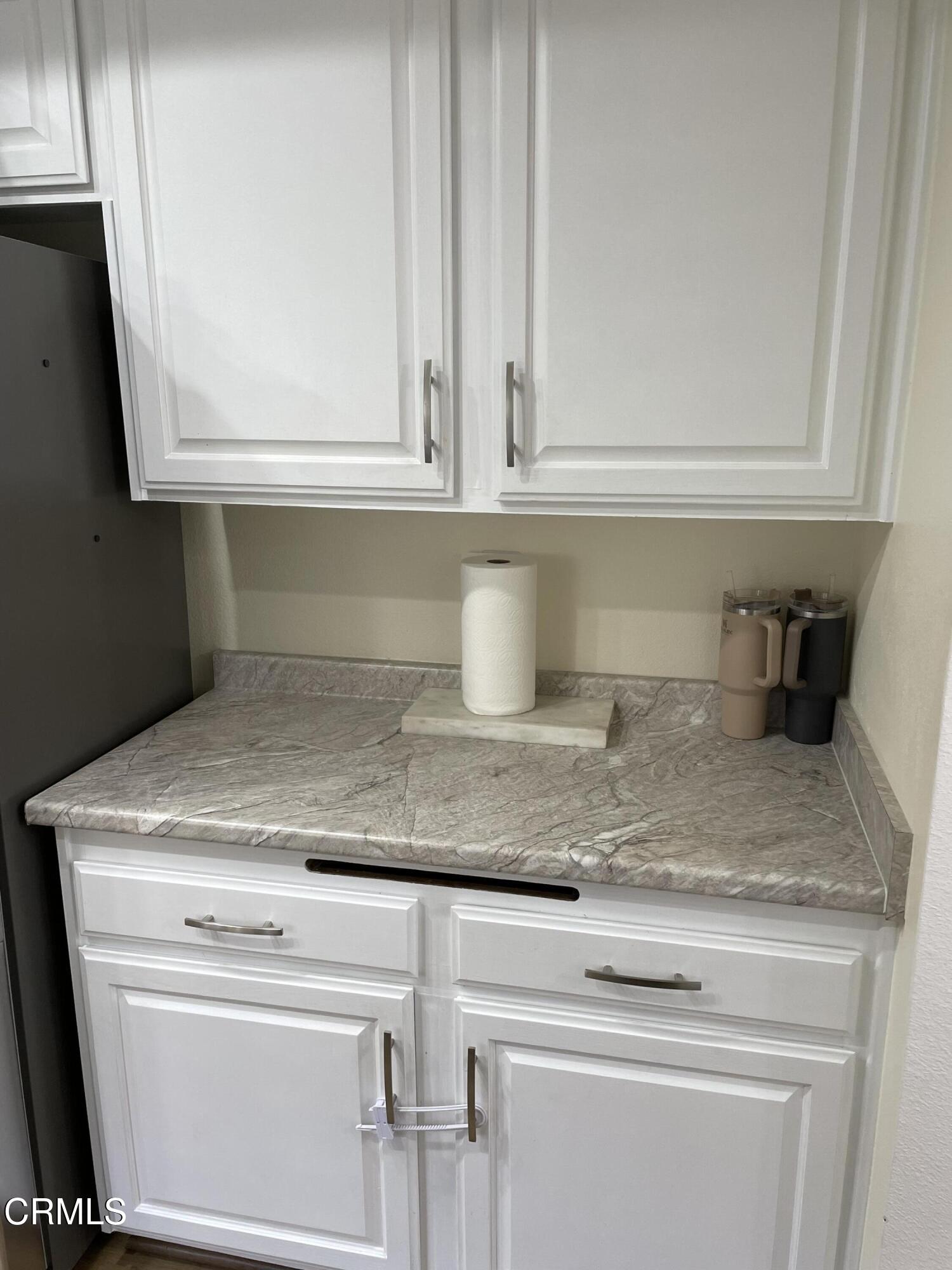 2585 Pheasant Hill Road Camarillo, CA 93010 - Photo 7 of 23 a kitchen with granite countertop white cabinets and a white stove