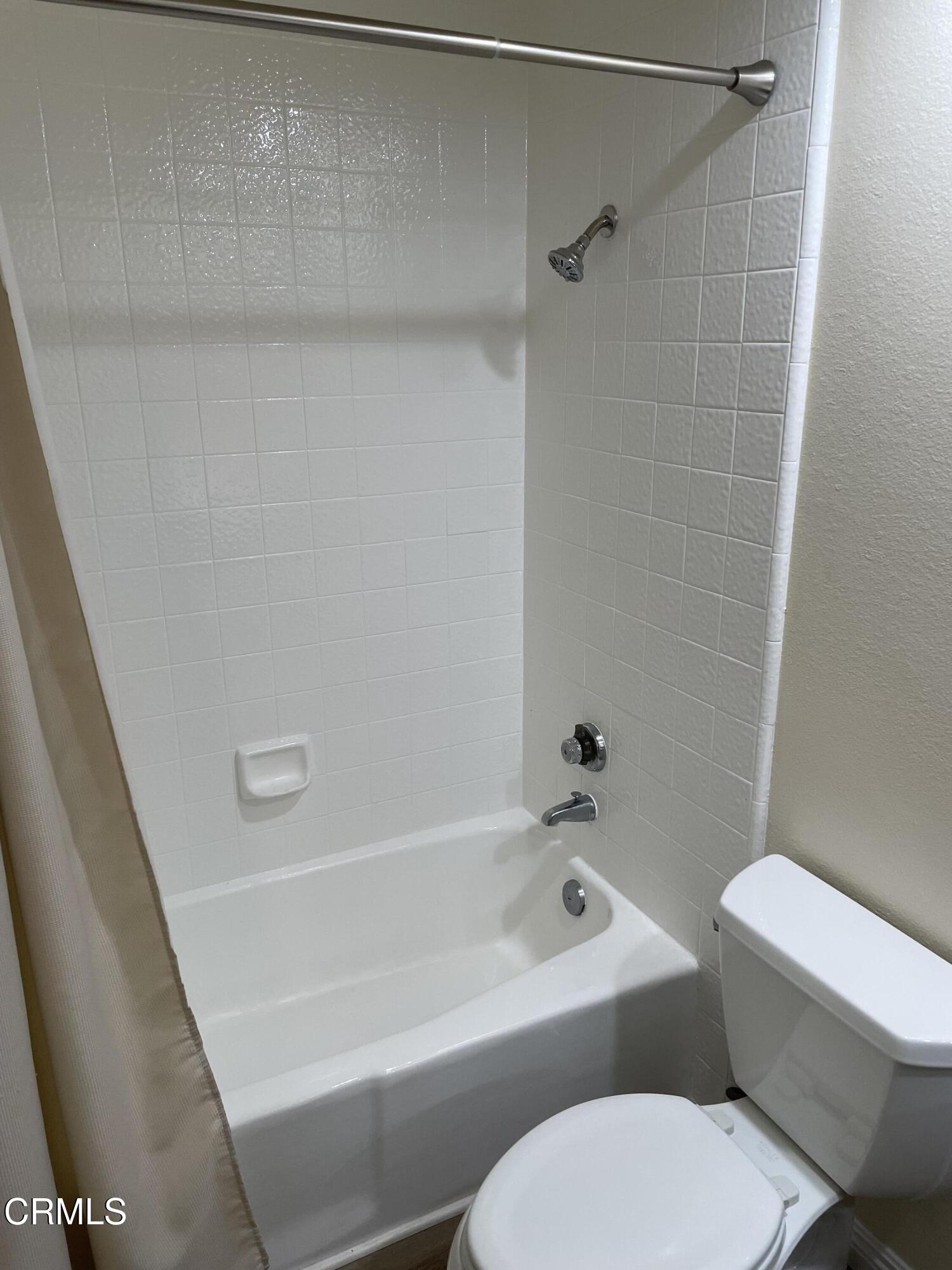 2585 Pheasant Hill Road Camarillo, CA 93010 - Photo 10 of 23 a white toilet and tub sitting next to a bathroom sink