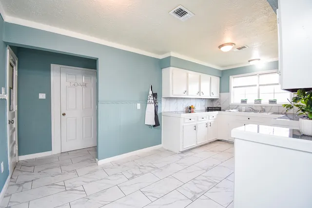 a kitchen with a sink a cabinets and window