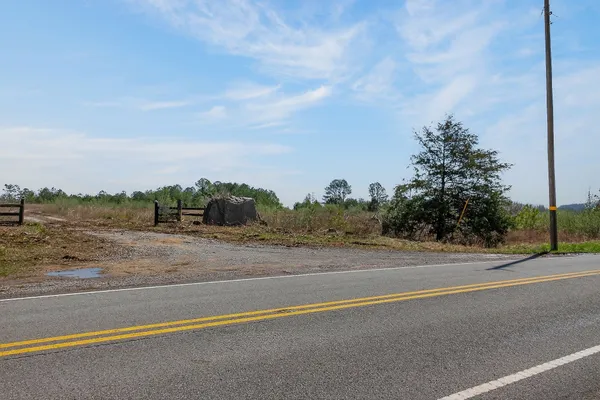 a view of a field and mountains in the background