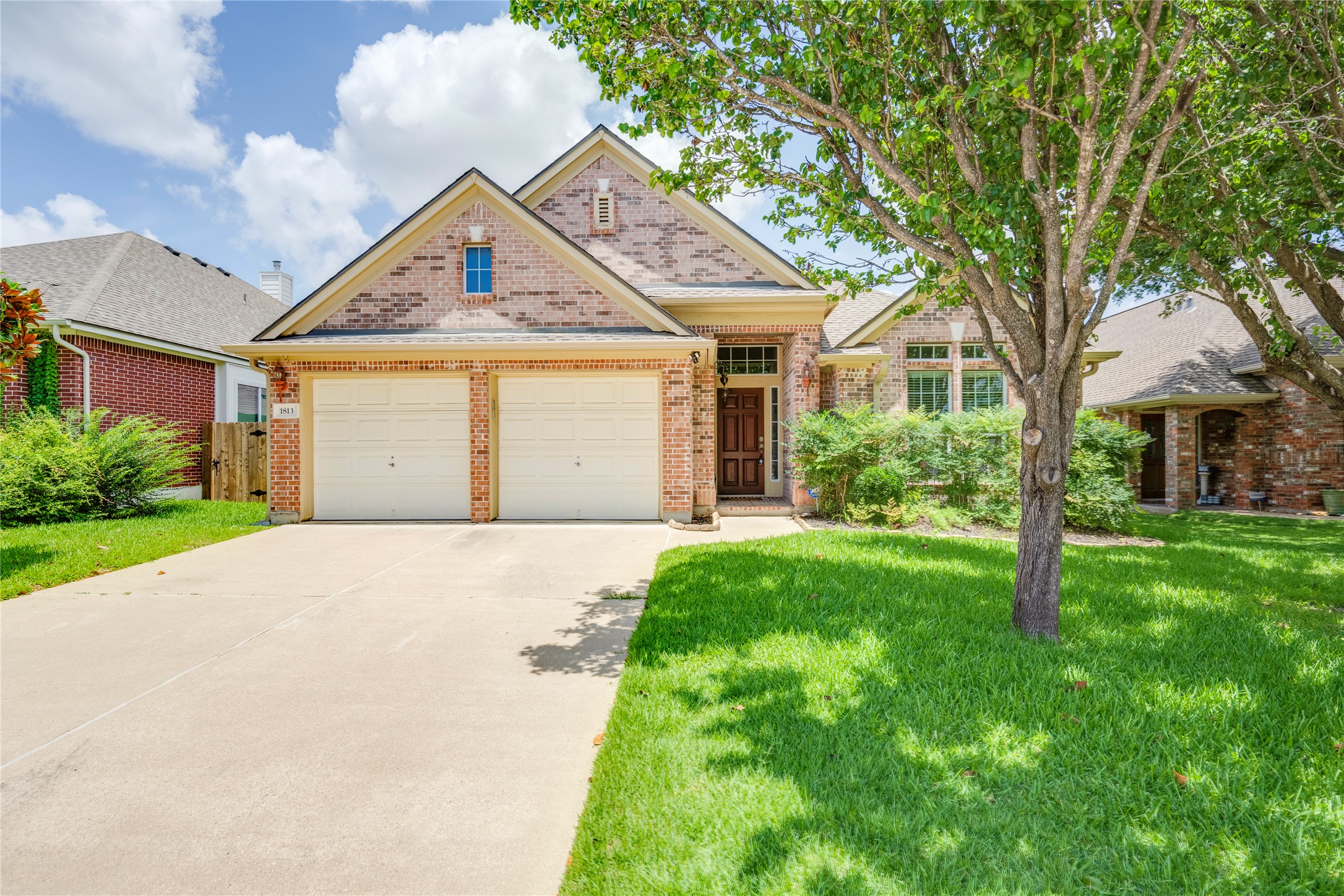 1813 Nelson Ranch Loop Cedar Park, TX 78613 - Photo 2 of 39 A well-maintained brick facade and verdant lawn present inviting curb appeal.