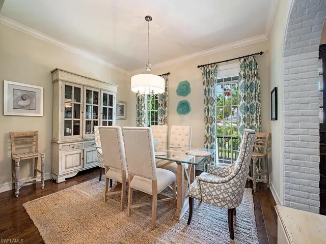 a dining room with furniture a window and a chandelier
