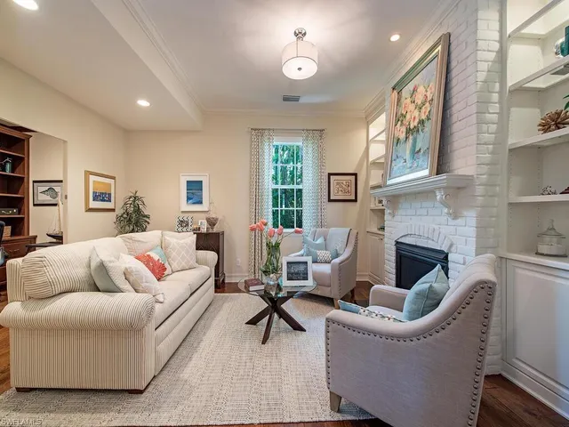 a living room with furniture fireplace and a table