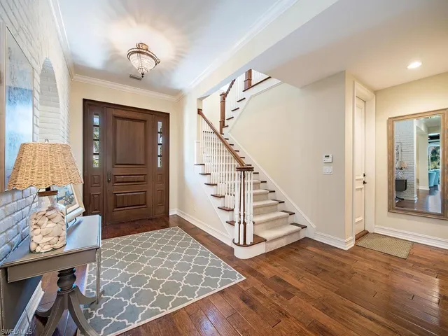 a view of a hallway view with wooden floor and staircase