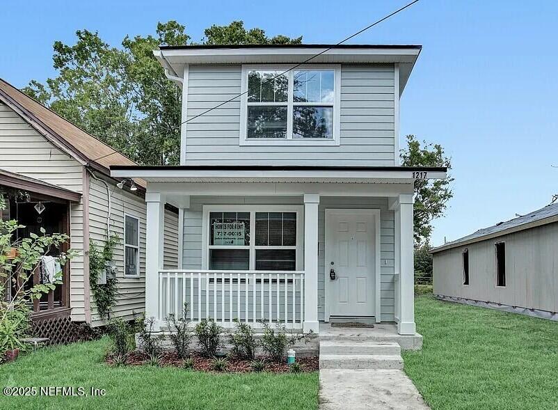 1217 Grothe Street Jacksonville, FL 32209 - Photo 1 of 1 a front view of a house with a garden