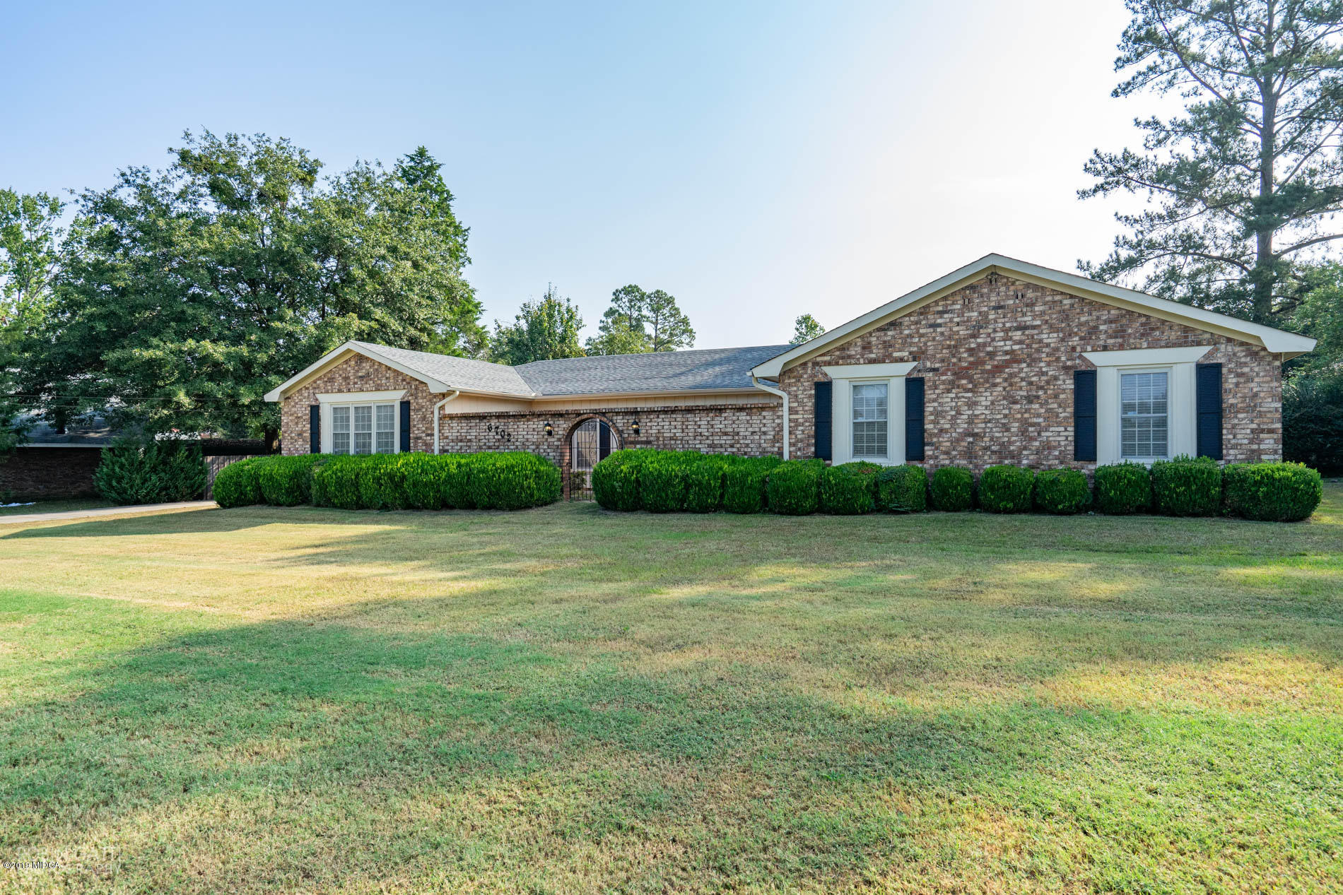 a front view of house with yard and green space