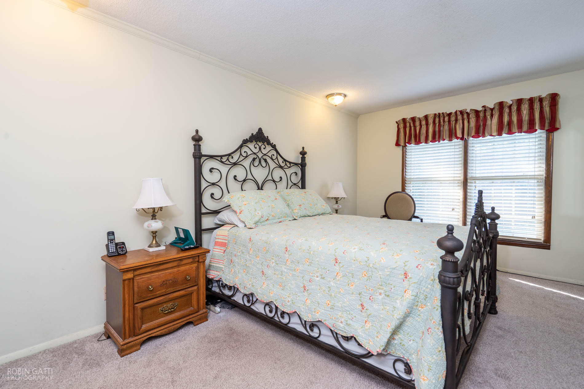6702 Goodall Mill Road Macon, GA 31216 - Photo 21 of 32 a bedroom with a bed and a table in it