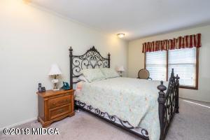 6702 Goodall Mill Road Macon, GA 31216 - Photo 23 of 32 a bedroom with a bed and a table