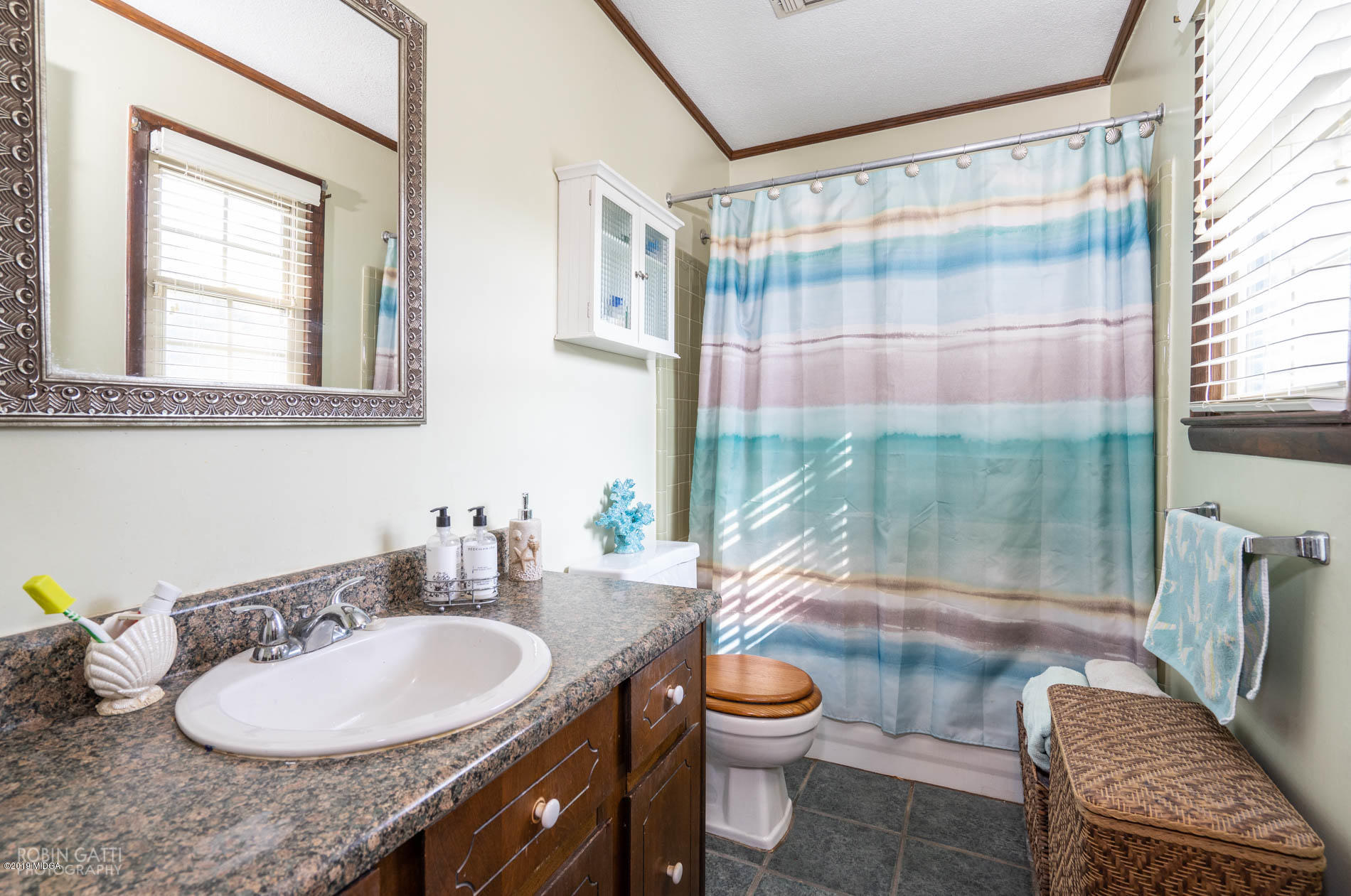 6702 Goodall Mill Road Macon, GA 31216 - Photo 24 of 32 a bathroom with a granite countertop sink mirror vanity and toilet