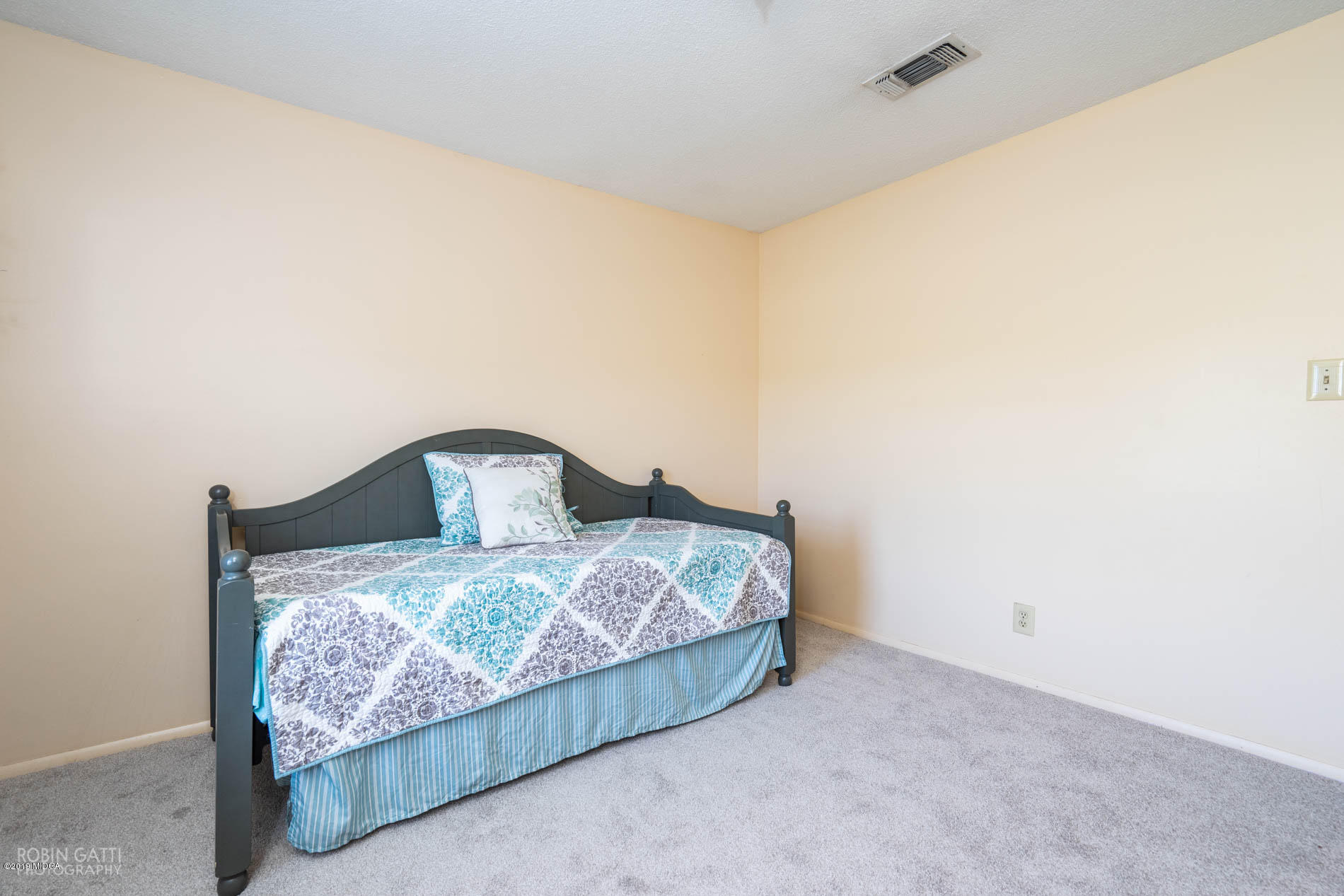 6702 Goodall Mill Road Macon, GA 31216 - Photo 26 of 32 a bed sitting in a bedroom next to a wall