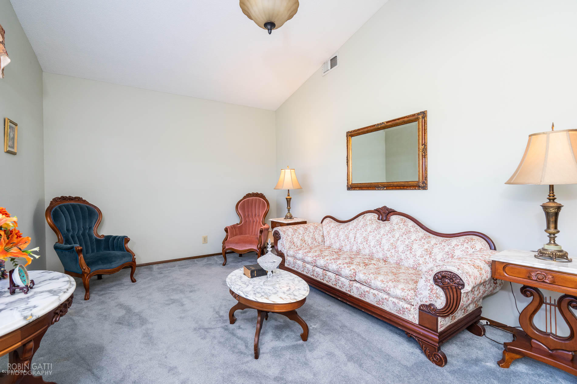 6702 Goodall Mill Road Macon, GA 31216 - Photo 10 of 32 a bedroom with a bed and a chandelier