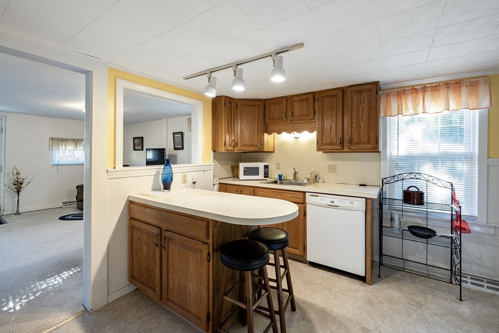 111 Thaddeus Street Chicopee, MA 01020 - Photo 12 of 32 a kitchen with sink cabinets and dining table