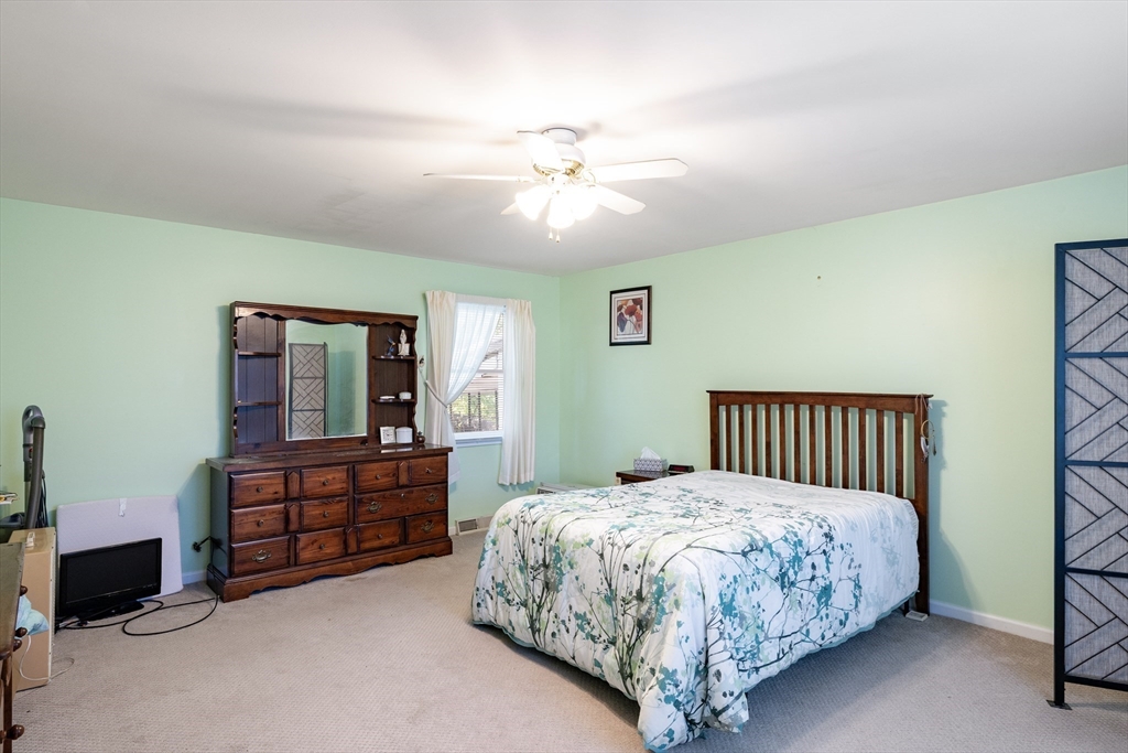111 Thaddeus Street Chicopee, MA 01020 - Photo 13 of 32 a bedroom with a bed dresser and a window