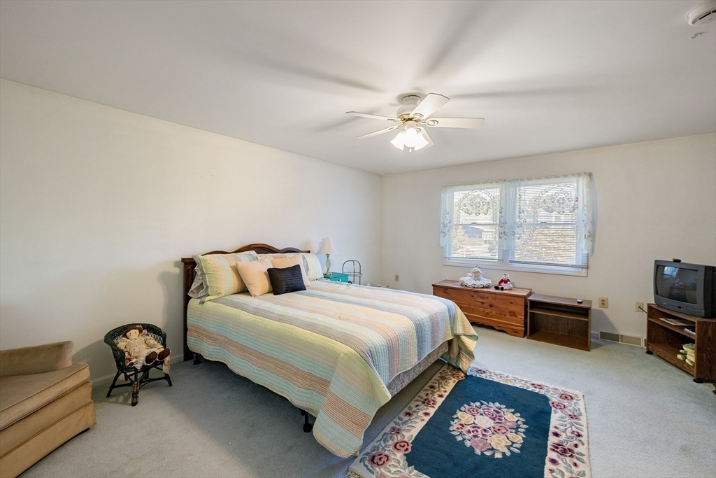 111 Thaddeus Street Chicopee, MA 01020 - Photo 17 of 32 a bedroom with a bed and a chandelier