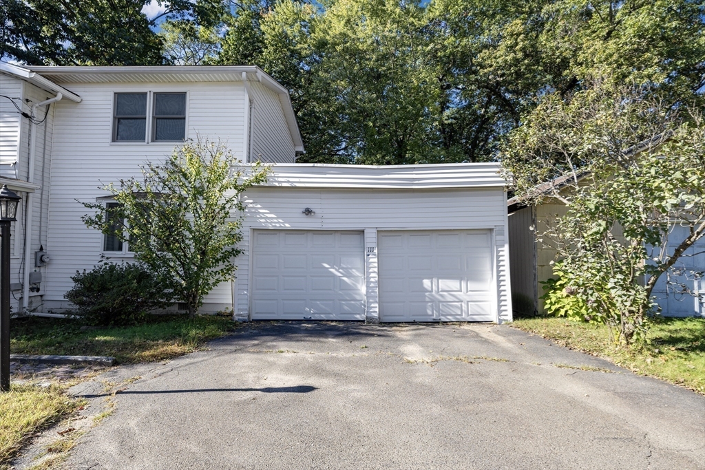 111 Thaddeus Street Chicopee, MA 01020 - Photo 29 of 32 a front view of a house with a yard and garage
