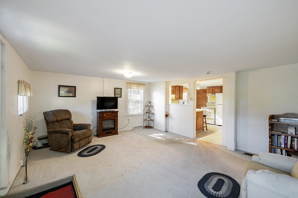 111 Thaddeus Street Chicopee, MA 01020 - Photo 5 of 32 a view of a livingroom with furniture and a flat screen tv