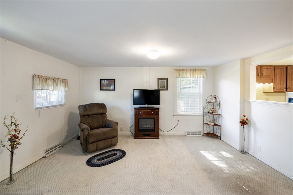 111 Thaddeus Street Chicopee, MA 01020 - Photo 7 of 32 a living room with furniture and a flat screen tv