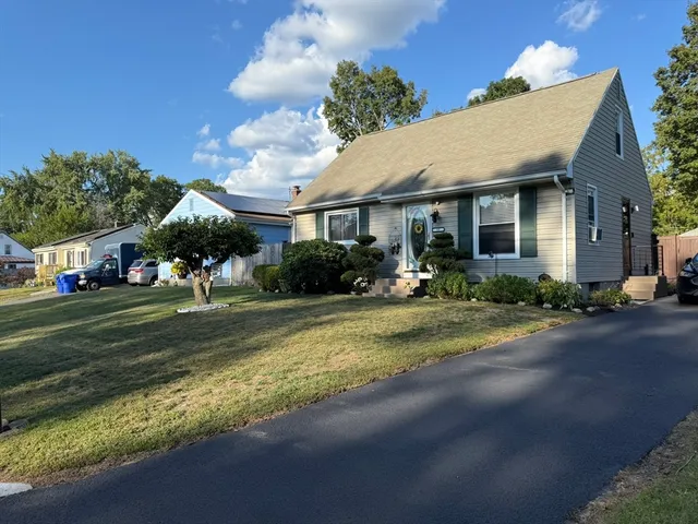 a front view of a house with a yard and a garage